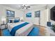 Bright bedroom with wood flooring, two windows, ceiling fan, and a large bed with blue bedding at 570 Harris Sw Ct, Marietta, GA 30060