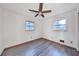 Simple bedroom with hardwood floors and a ceiling fan, offering a blank canvas for personalization at 570 Harris Sw Ct, Marietta, GA 30060