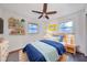 Bright bedroom with white walls, a ceiling fan, and colorful decor, including bookshelves with toys and books at 570 Harris Sw Ct, Marietta, GA 30060