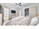 Bedroom featuring hardwood floors, a large TV, a spacious closet, and two entryways at 570 Harris Sw Ct, Marietta, GA 30060