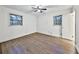 Bedroom featuring hardwood floors, two windows, and a doorway at 570 Harris Sw Ct, Marietta, GA 30060