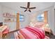 Charming pink bedroom with a desk and chair, perfect for a room, complemented by a ceiling fan at 570 Harris Sw Ct, Marietta, GA 30060
