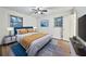 Bright bedroom with wood flooring, two windows, ceiling fan, and a large bed with yellow bedding at 570 Harris Sw Ct, Marietta, GA 30060