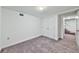 Bedroom view featuring carpeting, closet and door leading to stairway at 570 Harris Sw Ct, Marietta, GA 30060