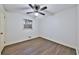 Minimalist bedroom with hardwood floors, natural light and ceiling fan provides a clean and comfortable space at 570 Harris Sw Ct, Marietta, GA 30060
