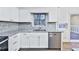 Bright kitchen with stainless steel appliances, granite countertops, and backyard view at 570 Harris Sw Ct, Marietta, GA 30060