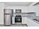 Modern kitchen featuring white cabinets and stainless steel appliances and oven at 570 Harris Sw Ct, Marietta, GA 30060