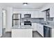 Modern kitchen featuring white cabinets, stainless steel appliances, and gray granite countertops at 570 Harris Sw Ct, Marietta, GA 30060