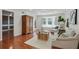 Bright living room with hardwood floors, a bay window, and a decorative armoire at 6851 Roswell Rd # D-6, Atlanta, GA 30328
