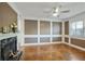 Stylish living room featuring a decorative fireplace, paneled walls, and parquet floors at 6851 Roswell Rd # D-6, Atlanta, GA 30328