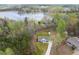 Stunning aerial view of a home on a wooded lot near a lake, showcasing the property's serene setting at 121 Tricias Way, Temple, GA 30179