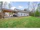 Large backyard with a covered patio, hot tub, and ample green space for outdoor enjoyment at 121 Tricias Way, Temple, GA 30179