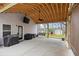 Inviting covered patio with a ceiling fan, outdoor television, and grill; perfect for outdoor living at 121 Tricias Way, Temple, GA 30179