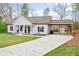 Charming single-story home with a welcoming front porch and a long driveway with carport at 121 Tricias Way, Temple, GA 30179