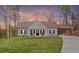 Charming single-story home with a welcoming front porch, well-manicured lawn, and attached carport at 121 Tricias Way, Temple, GA 30179
