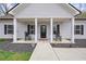 Charming front porch with classic columns and black shutters, adding elegance to the home's exterior at 121 Tricias Way, Temple, GA 30179