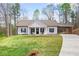 Charming single-story home with a well-maintained lawn, a covered carport, and classic rocking chairs at 121 Tricias Way, Temple, GA 30179