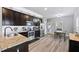 Modern kitchen with stainless steel appliances, granite countertops, and stylish dark wood cabinets at 121 Tricias Way, Temple, GA 30179