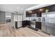 Open concept kitchen with granite countertops, stainless steel appliances, and view into living room at 121 Tricias Way, Temple, GA 30179