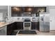 Stylish kitchen with granite counters, stainless appliances, and abundant dark wood cabinet storage at 121 Tricias Way, Temple, GA 30179