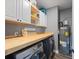 Well-organized laundry room with modern appliances, a folding counter, and ample storage at 121 Tricias Way, Temple, GA 30179