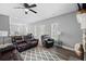 Open-concept living area with fireplace, leather furniture, and seamless flow to the kitchen at 121 Tricias Way, Temple, GA 30179