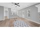 Open-concept living area showcasing hardwood floors, grey paint, and a view into the kitchen at 121 Tricias Way, Temple, GA 30179