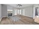 Comfortable living room with a stone fireplace, wood-look floors, and plenty of natural light at 121 Tricias Way, Temple, GA 30179
