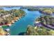 Aerial view of a beautiful lake with multiple docks and lakeside homes at 2220 Lanier Harbor Pt, Buford, GA 30518