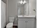 Cozy bathroom featuring a white vanity with closed storage and a framed mirror at 2220 Lanier Harbor Pt, Buford, GA 30518