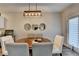 Dining area with hardwood floors and a round table, perfect for gatherings at 2220 Lanier Harbor Pt, Buford, GA 30518