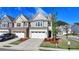 Charming townhome featuring a two-car garage, manicured lawn, and modern design at 2220 Lanier Harbor Pt, Buford, GA 30518