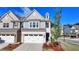 Well-maintained townhome with a two-car garage, neat landscaping, and stylish exterior at 2220 Lanier Harbor Pt, Buford, GA 30518
