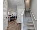 Open hallway showcasing staircase, wood floors, and access to the kitchen and dining areas at 2220 Lanier Harbor Pt, Buford, GA 30518