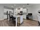 Modern kitchen with stainless steel refrigerator, granite countertops, and an island with barstools at 2220 Lanier Harbor Pt, Buford, GA 30518
