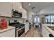 Cozy kitchen with stainless steel appliances, white cabinets, and granite countertops overlooks dining at 2220 Lanier Harbor Pt, Buford, GA 30518