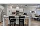 Updated kitchen offers granite counters, white cabinetry, stainless appliances, and an island with seating at 2220 Lanier Harbor Pt, Buford, GA 30518