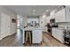 Spacious kitchen with white cabinets, stainless appliances, and a granite-topped island with stools at 2220 Lanier Harbor Pt, Buford, GA 30518