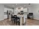 Open kitchen featuring stainless appliances, granite countertops, and a center island with seating at 2220 Lanier Harbor Pt, Buford, GA 30518