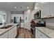 Bright kitchen with modern appliances, white cabinets, granite counters, and wood-look floors at 2220 Lanier Harbor Pt, Buford, GA 30518