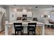 Bright kitchen boasts granite countertops, white cabinets, and a large island for seating at 2220 Lanier Harbor Pt, Buford, GA 30518