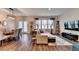 Open-concept living room with a large sofa, modern lighting, and hardwood floors at 2220 Lanier Harbor Pt, Buford, GA 30518