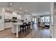 Bright open-concept kitchen, dining, and living area, featuring modern finishes and hardwood floors at 2220 Lanier Harbor Pt, Buford, GA 30518