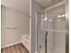 Modern main bathroom with a separate tub and glass enclosed shower, and wood look floors at 2220 Lanier Harbor Pt, Buford, GA 30518