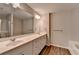 Elegant main bathroom with double sink vanity, tub, and glass-enclosed shower at 2220 Lanier Harbor Pt, Buford, GA 30518