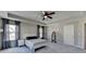 Spacious main bedroom with tray ceiling, ceiling fan, and ample natural light at 2220 Lanier Harbor Pt, Buford, GA 30518