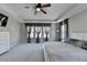 Large main bedroom with ceiling fan, tray ceiling, and lots of windows for natural light at 2220 Lanier Harbor Pt, Buford, GA 30518