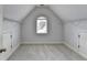 Finished attic with a window and storage space with carpet at 2723 Ivy Bluff Ct, Buford, GA 30519