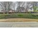 View of backyard showing landscaping, fence and the rear of other houses at 2723 Ivy Bluff Ct, Buford, GA 30519