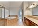Bathroom with a large tub, double sink vanity, and a view to the next room at 2723 Ivy Bluff Ct, Buford, GA 30519
